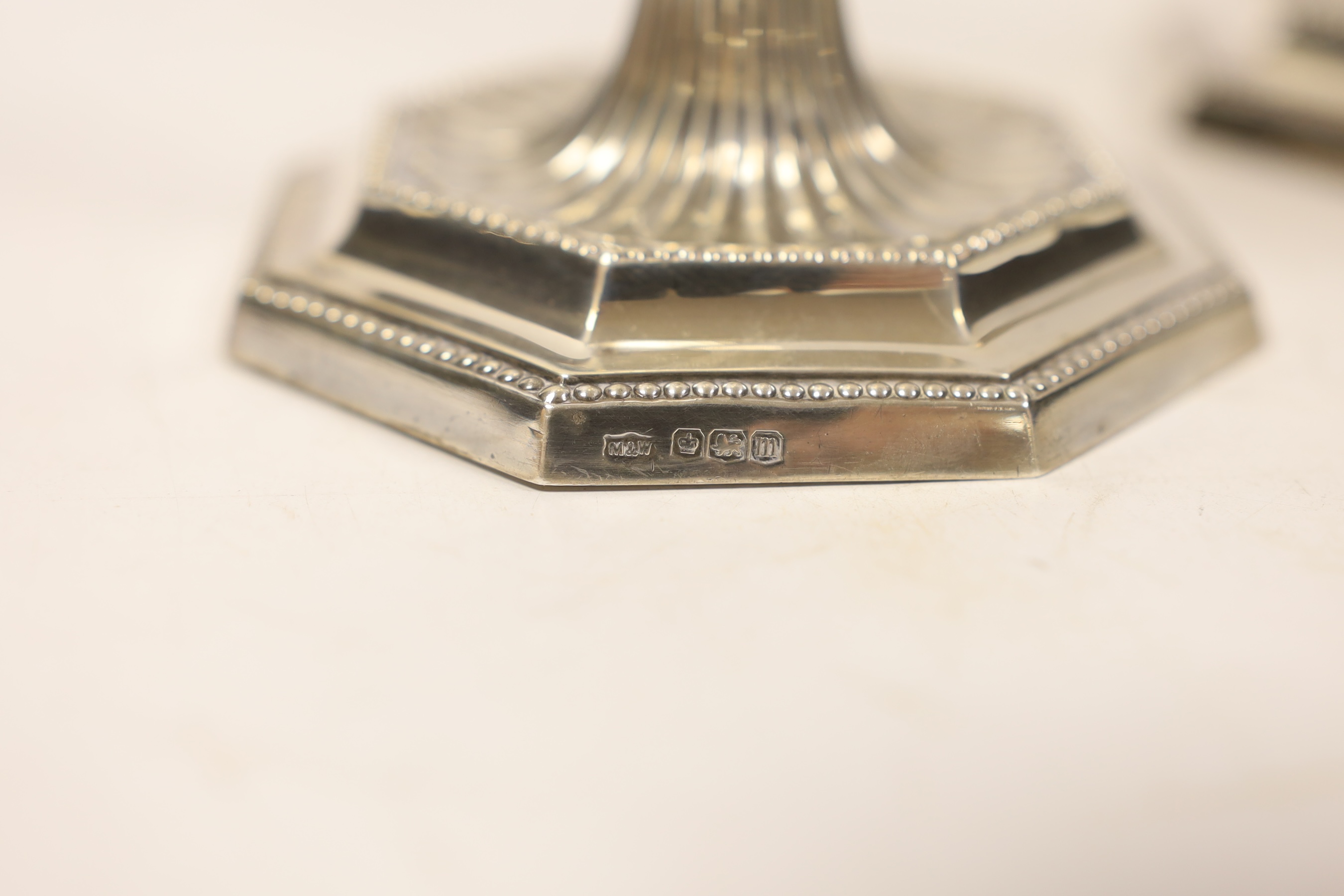 A pair of George V silver mounted candlesticks, on octagonal bases, Mappin & Webb, Sheffield, 1929, 20.9cm, weighted.